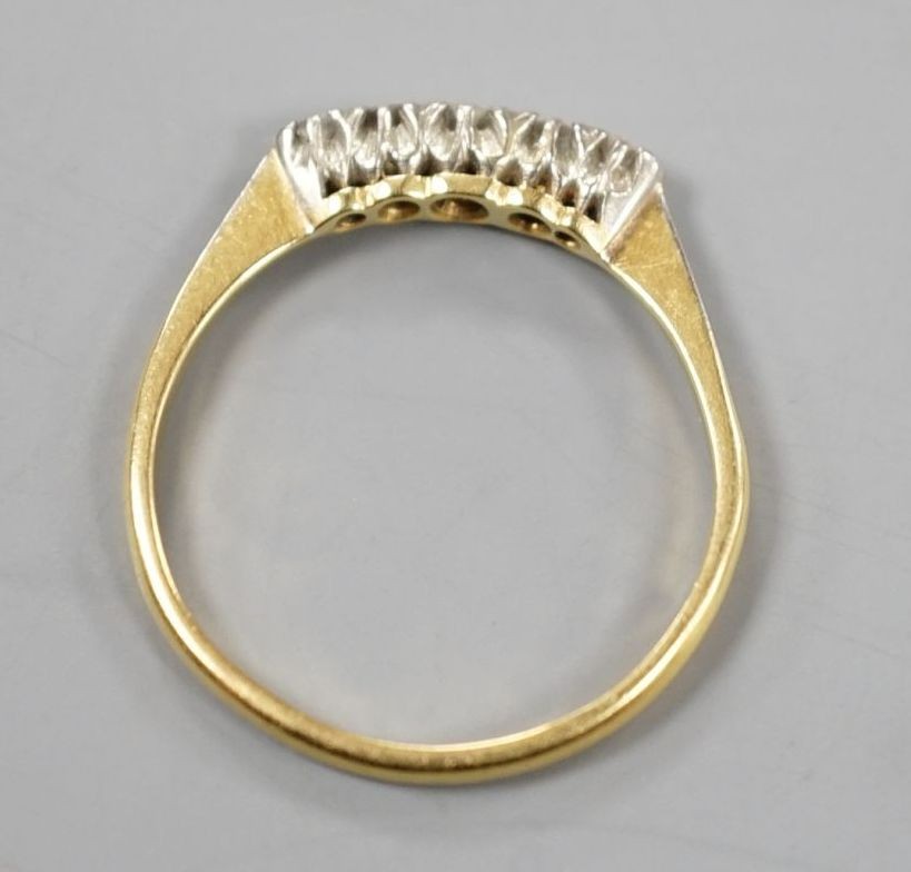 An 18ct and plat. five stone diamond set ring, size R, gross weight 2.4 grams.